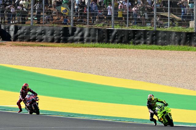Pertamina Enduro VR46 Racing Team's Italian rider Fabio Di Giannantonio (R) and Ducati Lenovo's Spanish rider Marc Marquez compete during the MotoGP sprint of the Grand Prix of Brazil at the Ayrton Senna International racetrack in Goiania, state of Goias, Brazil, on March 21, 2026. (Photo by EVARISTO SA / AFP)