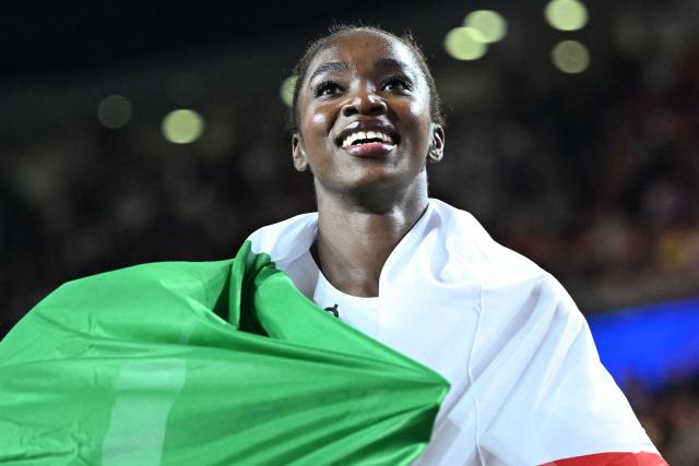 Italy's Zaynab Dosso displays her country's flag after winning the women's 60m final during the World Athletics Indoor Championships Kujawy Pomorze 2026 in Torun, Poland on March 21, 2026. (Photo by Kirill KUDRYAVTSEV / AFP)