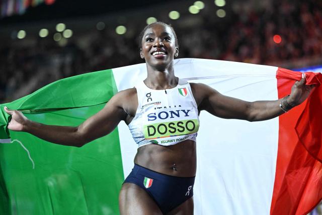 Italy's Zaynab Dosso displays her country's flag after winning the women's 60m final during the World Athletics Indoor Championships Kujawy Pomorze 2026 in Torun, Poland on March 21, 2026. (Photo by Kirill KUDRYAVTSEV / AFP)