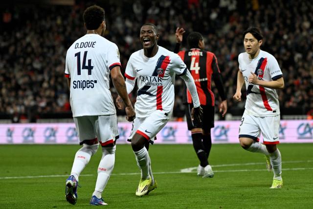 Paris Saint-Germain's Portuguese defender #25 Nuno Mendes (2nd L) celebrates after scoring a goal during the French L1 football match between OGC Nice and Paris Saint-Germain at the Allianz Riviera stadium in Nice, southern France, on March 21, 2026. (Photo by Miguel MEDINA / AFP)