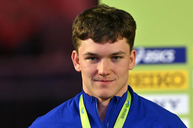 Silver medallist USA's Heath Baldwin celebrates on the podium for the men's heptathlon during the World Athletics Indoor Championships Kujawy Pomorze 2026 in Torun, Poland on March 21, 2026. (Photo by Andrej ISAKOVIC / AFP)