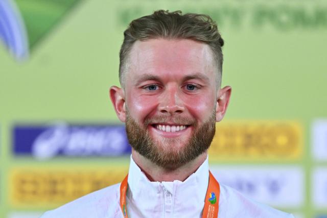Britain's Josh Kerr celebrates with his gold medal on the podium for the men's 3000 metres event during the World Athletics Indoor Championships Kujawy Pomorze 2026 in Torun, Poland on March 21, 2026. (Photo by Andrej ISAKOVIC / AFP)