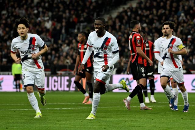 Paris Saint-Germain's Portuguese defender #25 Nuno Mendes (C) celebrates after scoring a goal during the French L1 football match between OGC Nice and Paris Saint-Germain at the Allianz Riviera stadium in Nice, southern France, on March 21, 2026. (Photo by Miguel MEDINA / AFP)