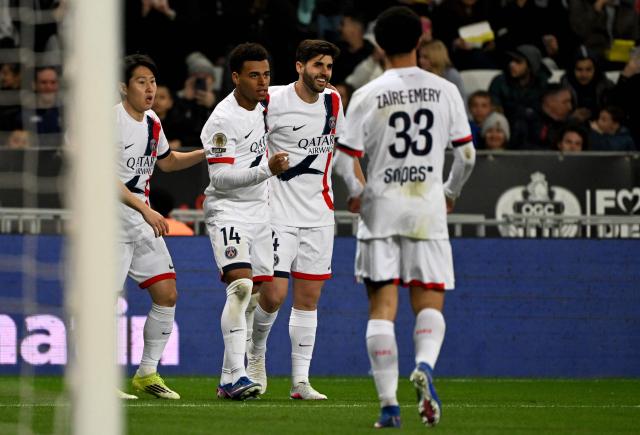 Paris Saint-Germain's French midfielder #14 Desire Doue (2nd L) celebrates with team mates Paris Saint-Germain's South Korean midfielder #19 Lee Kang-in, Paris Saint-Germain's Brazilian defender #04 Lucas Beraldo and Paris Saint-Germain's French midfielder #33 Warren Zaire-Emery after scoring a goal during the French L1 football match between OGC Nice and Paris Saint-Germain at the Allianz Riviera stadium in Nice, southern France, on March 21, 2026. (Photo by Miguel MEDINA / AFP)