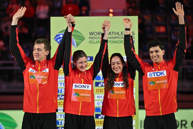 Gold medallists Belgium's Jonathan Sacoor (R), Belgium's Ilana Hanssens, Belgium's Helena Ponette and Belgium's Julien Watrin celebrate on the podium for the 4x400 relay during the World Athletics Indoor Championships Kujawy Pomorze 2026 in Torun, Poland on March 21, 2026. (Photo by Andrej ISAKOVIC / AFP)