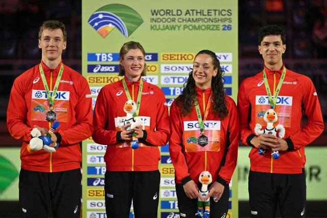 Gold medallists Belgium's Jonathan Sacoor (R), Belgium's Ilana Hanssens, Belgium's Helena Ponette and Belgium's Julien Watrin celebrate on the podium for the 4x400 relay during the World Athletics Indoor Championships Kujawy Pomorze 2026 in Torun, Poland on March 21, 2026. (Photo by Andrej ISAKOVIC / AFP)