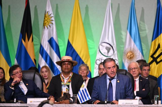 Uruguay's President Yamandu Orsi (R) speaks after receiving the pro tempore presidency from Colombia's President Gustavo Petro (L) during the X Summit of Heads of State and Government, within the framework of the CELAC-Africa High-Level Forum, in Bogota on March 21, 2026. (Photo by RAUL ARBOLEDA / AFP)