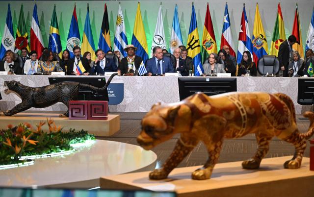 Uruguay's President Yamandu Orsi (C, right) speaks after receiving the pro tempore presidency from Colombia's President Gustavo Petro (C, left) during the X Summit of Heads of State and Government, within the framework of the CELAC-Africa High-Level Forum, in Bogota on March 21, 2026. (Photo by Raul ARBOLEDA / AFP)