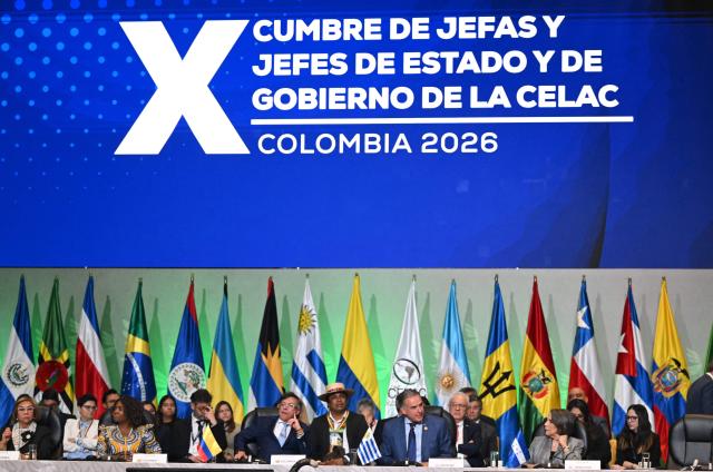 Uruguay's President Yamandu Orsi (C, right) speaks after receiving the pro tempore presidency from Colombia's President Gustavo Petro (C, left) during the X Summit of Heads of State and Government, within the framework of the CELAC-Africa High-Level Forum, in Bogota on March 21, 2026. (Photo by Raul ARBOLEDA / AFP)