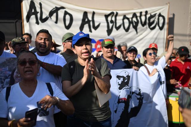 A woman shouts slogans during a demonstration in solidarity with Cuba and against the US embargo, under the slogan “Cuba is not a threat,” outside the Cuban embassy in San Salvador, on March 21, 2026. AFP (Photo by Marvin RECINOS / AFP)