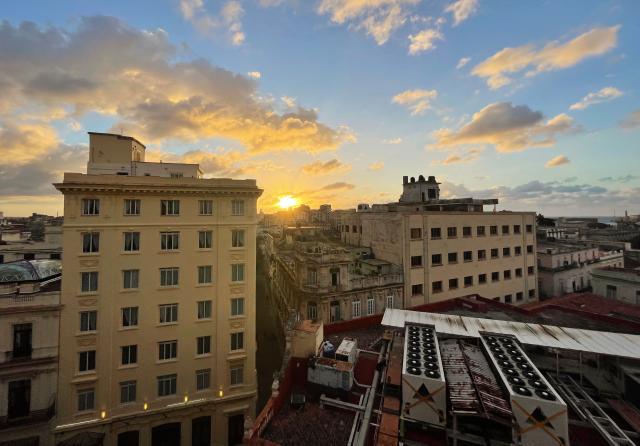 The sun sets during a nation wide blackout in Havana on March 21, 2026. A power outage struck the entire island of Cuba on March 21, 2026, the energy ministry said, in the second nationwide blackout in less than a week as its grid struggles under a US oil blockade. (Photo by Laurent THOMET / AFP)