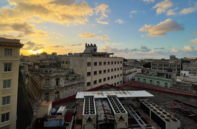 The sun sets during a nation wide blackout in Havana on March 21, 2026. A power outage struck the entire island of Cuba on March 21, 2026, the energy ministry said, in the second nationwide blackout in less than a week as its grid struggles under a US oil blockade. (Photo by Laurent THOMET / AFP)