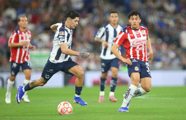 Monterrey's defender #03 Gerardo Arteaga and Guadalajara's US defender #37 Richard Ledezma fight for the ball during the Liga MX Clausura football match between Monterrey and Guadalajara at the BBVA Stadium in Monterrey, Mexico, on March 21, 2026. (Photo by Julio Cesar AGUILAR / AFP)