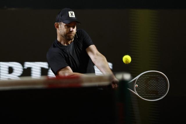 US former player Andrew Roddick returns during an exhibition match against Argentina's former tennis players Diego Schwartzman (L) and Juan Martin Del Potro ahead of the Latin America Open Tournament in Sao Paulo, Brazil on March 21, 2026. (Photo by Miguel SCHINCARIOL / AFP)