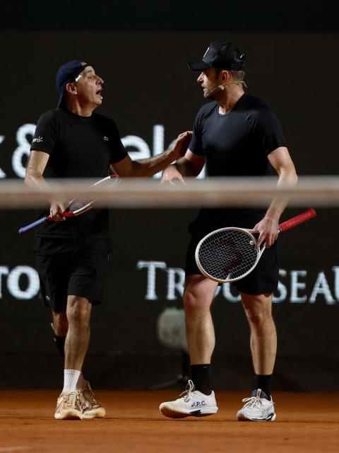 Brazil's former player Fernando Meligeni (L) and US former player Andrew Roddick  talk during an exhibition match against Argentina's former tennis players Diego Schwartzman (L) and Juan Martin Del Potro ahead of the Latin America Open Tournament in Sao Paulo, Brazil on March 21, 2026. (Photo by Miguel SCHINCARIOL / AFP)