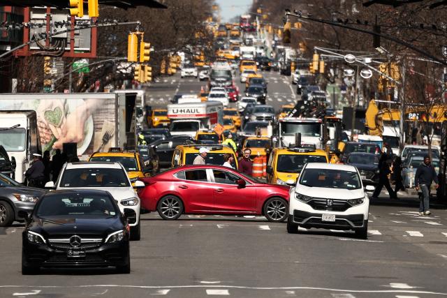 Pedestrians and cars move along Ninth Avenue in the Manhattan borough of New York City on March 21, 2026 (Photo by CHARLY TRIBALLEAU / AFP)