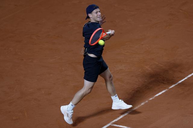 Argentine former tennis player Diego Schwartzman returns during an exhibition match against Brazil's former player Fernando Meligeni (L) and US former player Andrew Roddick ahead of the Latin America Open Tournament in Sao Paulo, Brazil on March 21, 2026. (Photo by Miguel SCHINCARIOL / AFP)