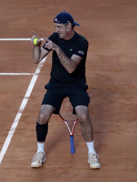 Brazil's former tennis player Fernando Meligeni reacts during an exhibition match against Argentina's former tennis players Diego Schwartzman (L) and Juan Martin Del Potro ahead of the Latin America Open Tournament in Sao Paulo, Brazil on March 21, 2026. (Photo by Miguel SCHINCARIOL / AFP)