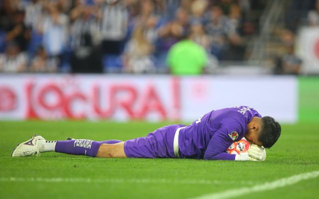 Guadalajara's goalkeeper #01 Raul Rangel catches the ball after stopping a last minute penalty kick to win the Liga MX Clausura football match between Monterrey and Guadalajara at the BBVA Stadium in Monterrey, Mexico, on March 21, 2026. (Photo by Julio Cesar AGUILAR / AFP)