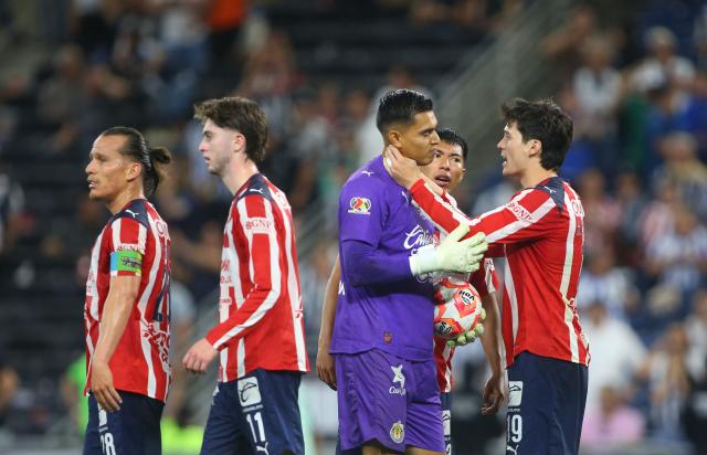 Guadalajara's goalkeeper #01 Raul Rangel is congratulated by teammates after stopping a last minute penalty kick to win the Liga MX Clausura football match between Monterrey and Guadalajara at the BBVA Stadium in Monterrey, Mexico, on March 21, 2026. (Photo by Julio Cesar AGUILAR / AFP)