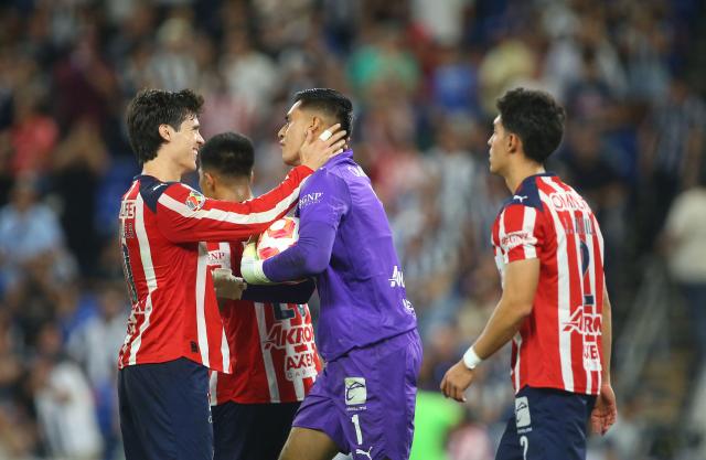 Guadalajara's goalkeeper #01 Raul Rangel is congratulated by teammates after stopping a last minute penalty kick to win the Liga MX Clausura football match between Monterrey and Guadalajara at the BBVA Stadium in Monterrey, Mexico, on March 21, 2026. (Photo by Julio Cesar AGUILAR / AFP)