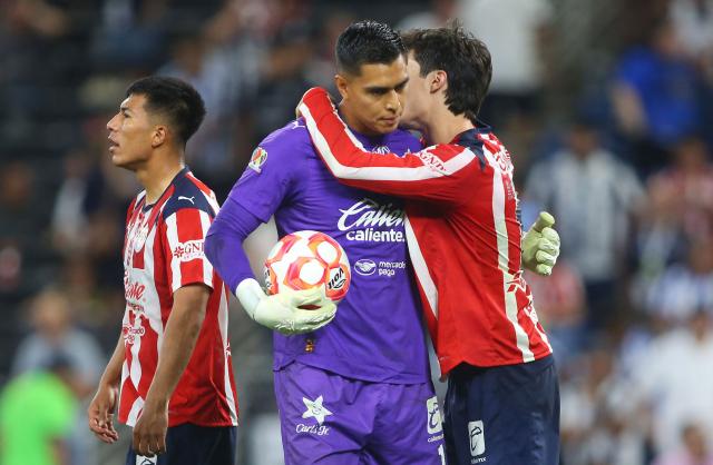 Guadalajara's goalkeeper #01 Raul Rangel is congratulated by teammates after stopping a last minute penalty kick to win the Liga MX Clausura football match between Monterrey and Guadalajara at the BBVA Stadium in Monterrey, Mexico, on March 21, 2026. (Photo by Julio Cesar AGUILAR / AFP)