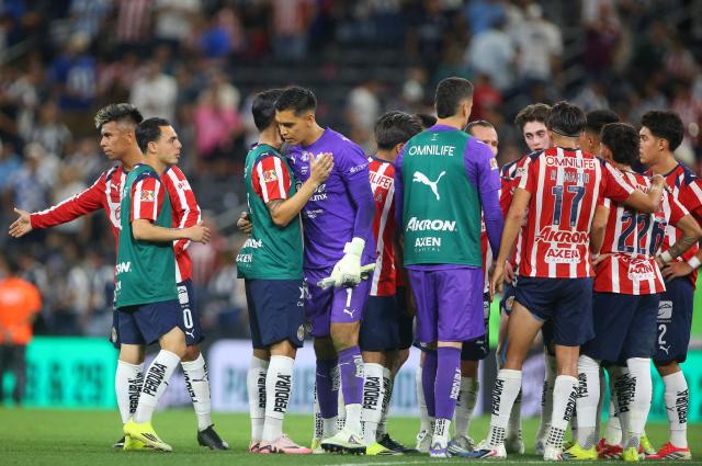 Guadalajara's goalkeeper #01 Raul Rangel is congratulated by teammates after stopping a last minute penalty kick to win the Liga MX Clausura football match between Monterrey and Guadalajara at the BBVA Stadium in Monterrey, Mexico, on March 21, 2026. (Photo by Julio Cesar AGUILAR / AFP)