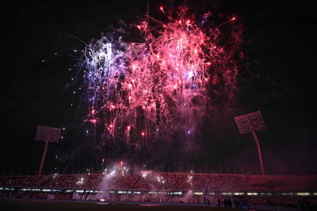 Fireworks explode before the Liga MX Clausura match between Pumas and America at Olimpico Universitario Stadium in Mexico City on March 21, 2026. (Photo by Alfredo ESTRELLA / AFP)