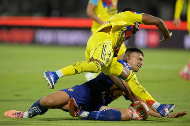 Pumas' forward #09 Guillermo Martinez (bottom) is fouled by America's Colombian defender #26 Cristian Borja to be awarded a penalty kick during the Liga MX Clausura match between Pumas and America at Olimpico Universitario Stadium in Mexico City on March 21, 2026. (Photo by Alfredo ESTRELLA / AFP)