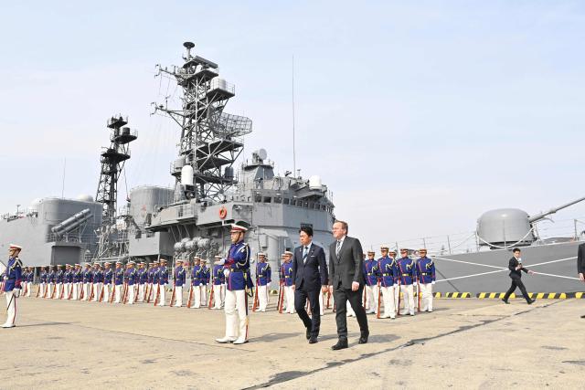 German Defence Minister Boris Pistorius and Japan's Defence Minister Shinjiro Koizumi inspect the honour guard during a welcome ceremony at the Japan Maritime Self-Defence Force (JMSDF)'s naval base in Yokosuka, south of Tokyo on March 22, 2026. (Photo by David MAREUIL / POOL / AFP)