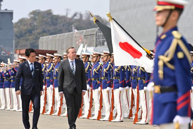 German Defence Minister Boris Pistorius and Japan's Defence Minister Shinjiro Koizumi inspect the honour guard during a welcome ceremony at the Japan Maritime Self-Defence Force (JMSDF)'s naval base in Yokosuka, south of Tokyo on March 22, 2026. (Photo by David MAREUIL / POOL / AFP)