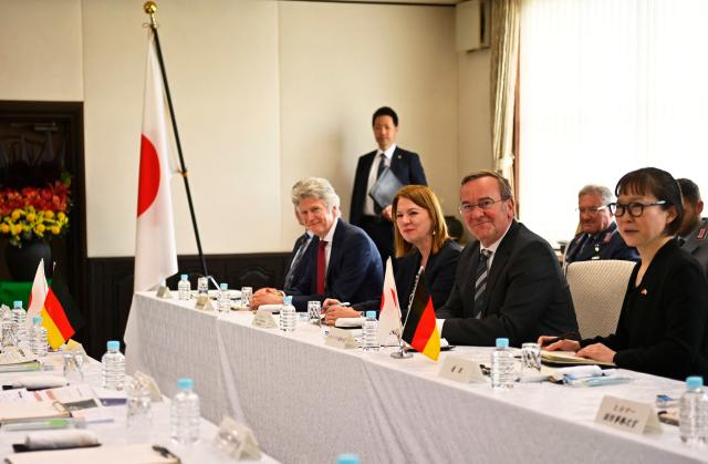 German Defence Minister Boris Pistorius (center-R) talks with his Japanese counterpart Shinjiro Koizumi (not pictured) during their meeting at the Japan Maritime Self-Defence Force (JMSDF)'s naval base in Yokosuka, south of Tokyo on March 22, 2026. (Photo by Ng Han Guan / POOL / AFP)