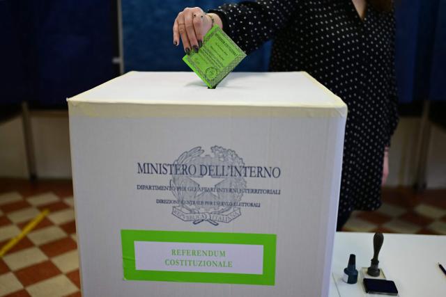 A woman casts her ballot in a polling station to vote for the Italian constitutional referendum on justice reform, in Milan, on March 22, 2026. (Photo by Piero CRUCIATTI / AFP)