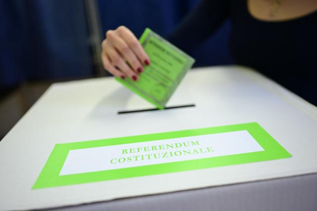 A woman casts her ballot in a polling station to vote for the Italian constitutional referendum on justice reform, in Milan, on March 22, 2026. (Photo by Piero CRUCIATTI / AFP)