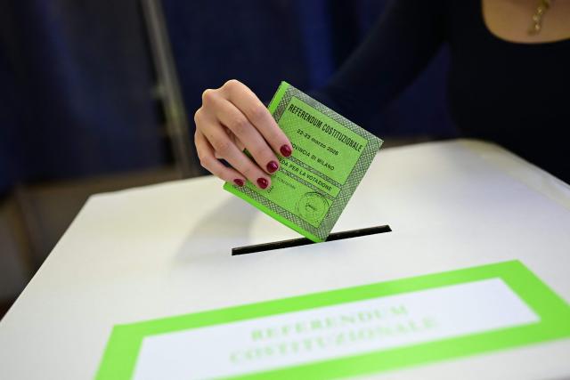 A woman casts her ballot in a polling station to vote for the Italian constitutional referendum on justice reform, in Milan, on March 22, 2026. (Photo by Piero CRUCIATTI / AFP)