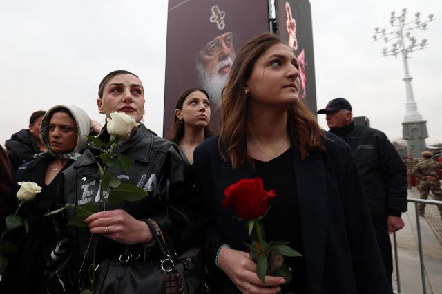 Mourners attend a funeral service of the late Georgia's Orthodox Patriarch Ilia II outside the Sameba Cathedral in Tbilisi on March 22, 2026. Georgian Orthodox Church leader Ilia II died on March 17, 2026 aged 93, the church said, after nearly half a century at the helm of one of the country's most powerful institutions. (Photo by Giorgi ARJEVANIDZE / AFP)