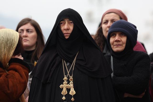 Mourners attend a funeral service of the late Georgia's Orthodox Patriarch Ilia II outside the Sameba Cathedral in Tbilisi on March 22, 2026. Georgian Orthodox Church leader Ilia II died on March 17, 2026 aged 93, the church said, after nearly half a century at the helm of one of the country's most powerful institutions. (Photo by Giorgi ARJEVANIDZE / AFP)