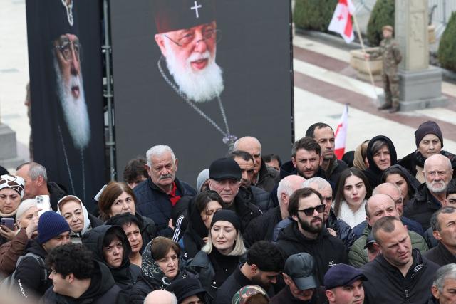 Mourners attend a funeral service of the late Georgia's Orthodox Patriarch Ilia II outside the Sameba Cathedral in Tbilisi on March 22, 2026. Georgian Orthodox Church leader Ilia II died on March 17, 2026 aged 93, the church said, after nearly half a century at the helm of one of the country's most powerful institutions. (Photo by Giorgi ARJEVANIDZE / AFP)