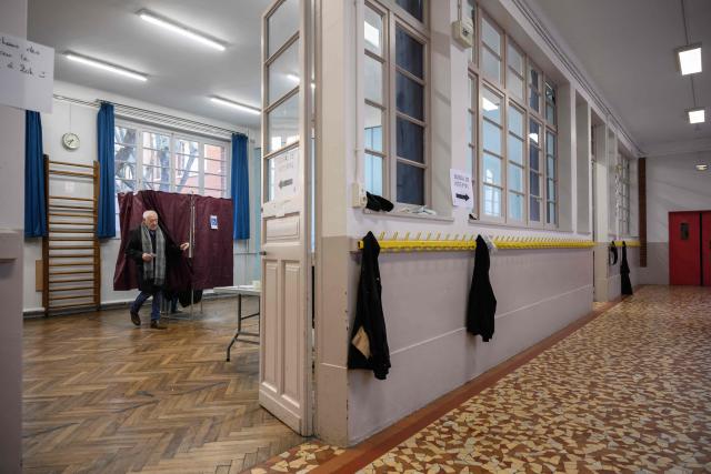 A voter prepares to cast their ballot during the second round of France's 2026 municipal elections in Toulouse, south-western France on March 22, 2026. (Photo by Ed JONES / AFP)