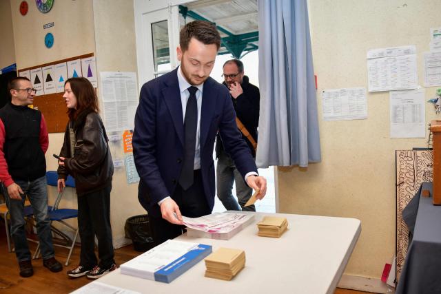 La France Insoumise (LFI) MP and Limoges' left-wing Popular Front - Union of the Social Left and The Ecologistes mayoral candidate Damien Maudet prepares to cast his vote during the second round of France's 2026 municipal elections in Limoges, central France on March 22, 2026. (Photo by Pascal LACHENAUD / AFP)
