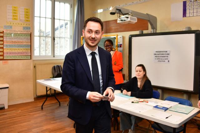 La France Insoumise (LFI) MP and Limoges' left-wing Popular Front - Union of the Social Left and The Ecologistes mayoral candidate Damien Maudet arrives to cast his vote during the second round of France's 2026 municipal elections in Limoges, central France on March 22, 2026. (Photo by Pascal LACHENAUD / AFP)