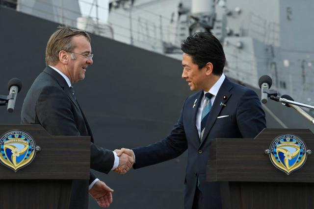 Germany's Defence Minister Boris Pistorius (L) and Japan's Defence Minister Shinjiro Koizumi (R) shake hands at the end of their joint press statement at the Japan Maritime Self-Defense Force naval base in Yokosuka, south of Tokyo on March 22, 2026. (Photo by David Mareuil / POOL / AFP)