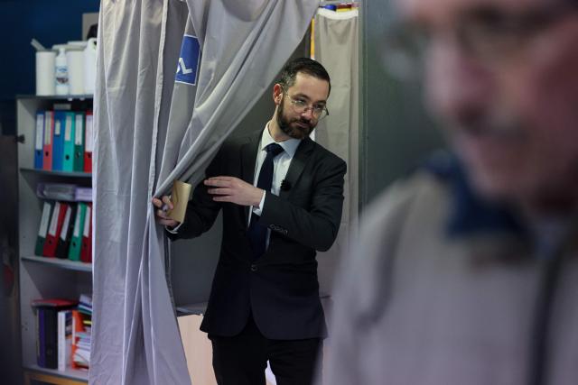 Roubaix' Left-wing La France Insoumise (LFI, Unbowed France) mayoral candidate David Guiraud exits a polling booth as he prepares to cast his vote during the second round of France's 2026 municipal elections in Roubaix, northern France on March 22, 2026. (Photo by Francois LO PRESTI / AFP)
