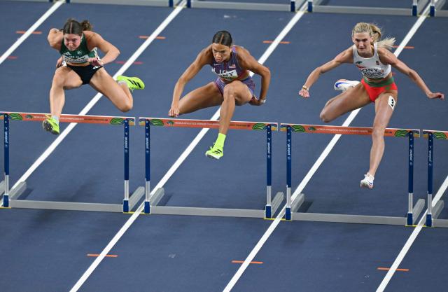 (LtoR) Ireland's Kate O'Connor, USA's Anna Hall and Hungary's Szabina Szucs compete in the women's pentathlon 60 metres hurdles heat 2 during the World Athletics Indoor Championships Kujawy Pomorze 2026 in Torun, Poland on March 22, 2026. (Photo by Andrej ISAKOVIC / AFP)