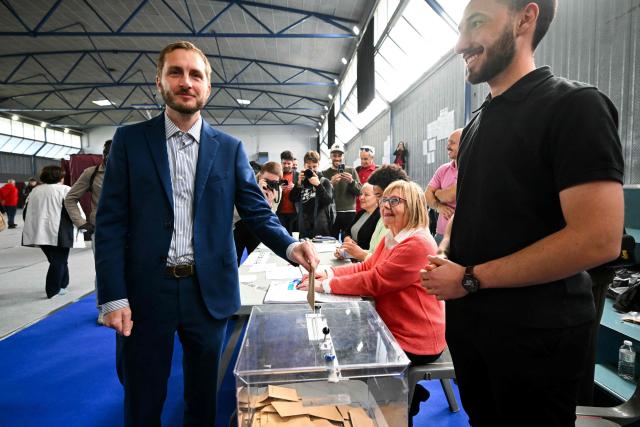 France's left-wing party La France Insoumise (LFI) MP and Toulouse's mayoral candidate François Piquemal (L) casts his vote during the second round of France's 2026 municipal elections in Toulouse, southwestern France on March 22, 2026. (Photo by Lionel BONAVENTURE / AFP)