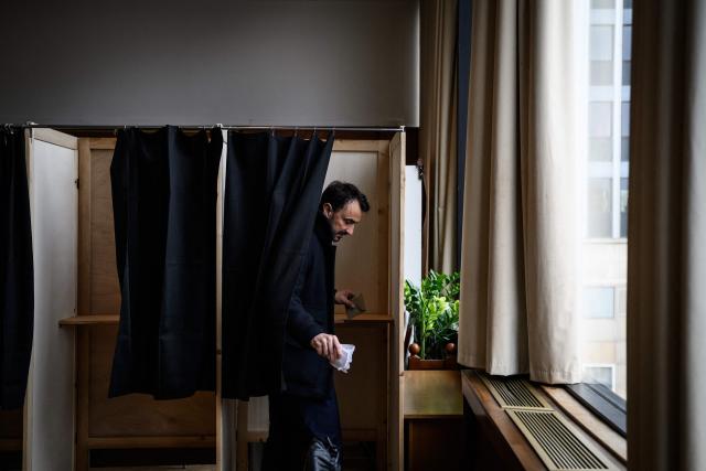 Incumbent mayor of Lyon and Europe-Ecology The Greens (EELV) party candidate for re-election Gregory Doucet exits a polling booth before casting his vote during the second round of France's 2026 municipal elections in Lyon, central eastern France on March 22, 2026. (Photo by JEFF PACHOUD / AFP)