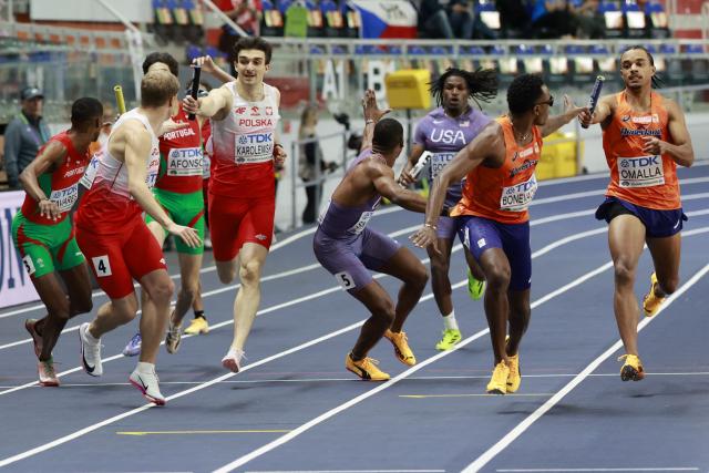 Athletes including Portugal's Ericsson Tavares, Portugal's Pedro Afonso, Poland's Marcin Karolewski, USA's Demarius Smith,USA's Elija Godwin, Netherlands' Liemarvin Bonevacia and Netherlands' Eugene Omalla competes in the men's 4x400 metres relay heat 1 during the World Athletics Indoor Championships Kujawy Pomorze 2026 in Torun, Poland on March 22, 2026. (Photo by Wojtek RADWANSKI / AFP)