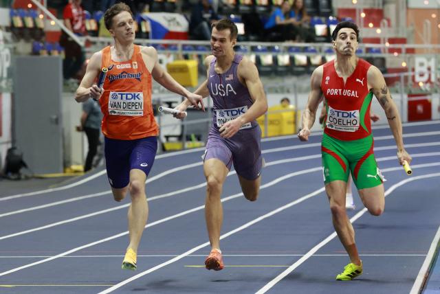 Netherlands' Tony Van Diepen (L), USA's TJ Tomlyanovich and Portugal's Joao Coelho run to the finish line in the men's 4x400 metres relay heat 1 during the World Athletics Indoor Championships Kujawy Pomorze 2026 in Torun, Poland on March 22, 2026. (Photo by Wojtek RADWANSKI / AFP)