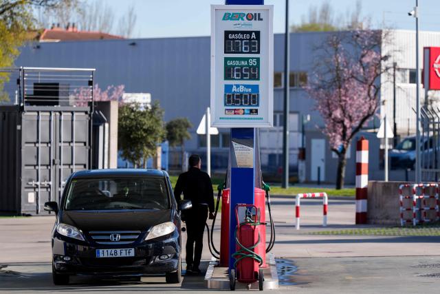 A photo taken on March 22, 2026 shows prices of combustible per litre displayed at a petrol station in Burgos, northern Spain. Spanish Prime Minister announced on March 20 a sweeping package worth five billion euros ($5.8 billion) aimed at cushioning the economic impact of the Middle East war, including cuts to value-added tax on gas and fuel expected to reduce pump prices by as much as 30 euro cents per litre, or roughly 20 euros per tank for the average car. (Photo by CESAR MANSO / AFP)