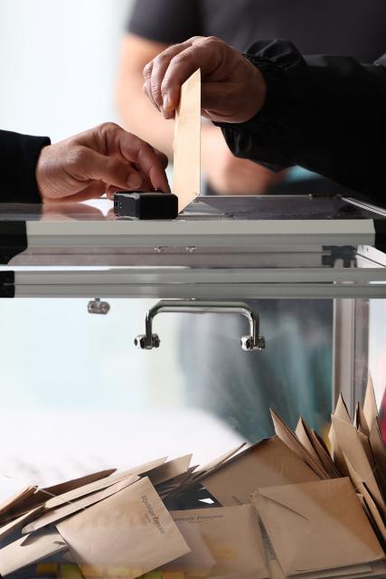 Voters cast their ballots at a polling station during the second round of France's 2026 municipal elections in Strasbourg, eastern France on March 22, 2026. (Photo by FREDERICK FLORIN / AFP)